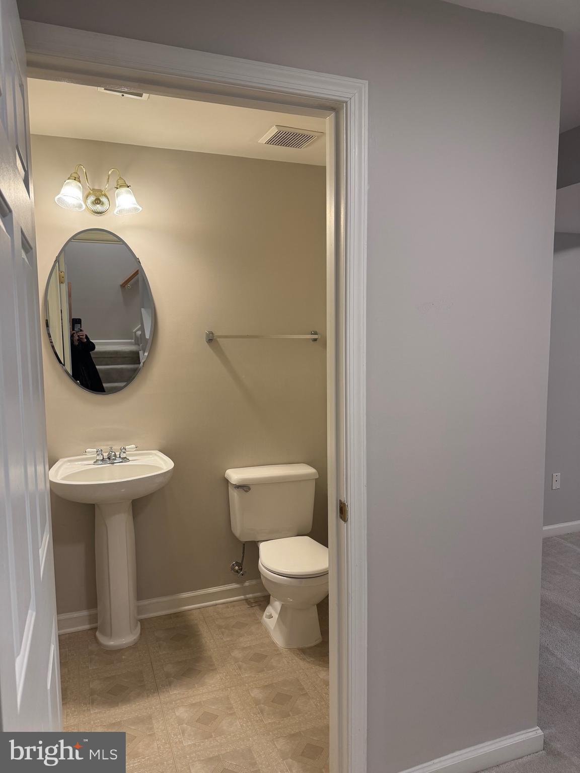 14342 Papilion Way Centreville, VA 20121 - Photo 13 of 46 a bathroom with a toilet sink and mirror