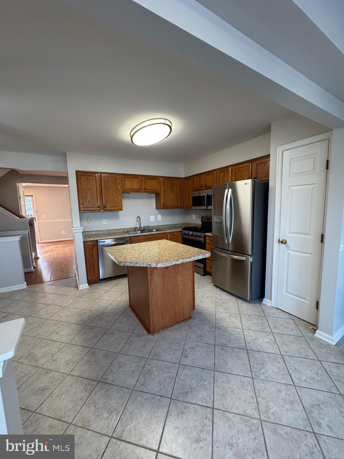 14342 Papilion Way Centreville, VA 20121 - Photo 23 of 46 a kitchen with stainless steel appliances granite countertop a refrigerator and a stove