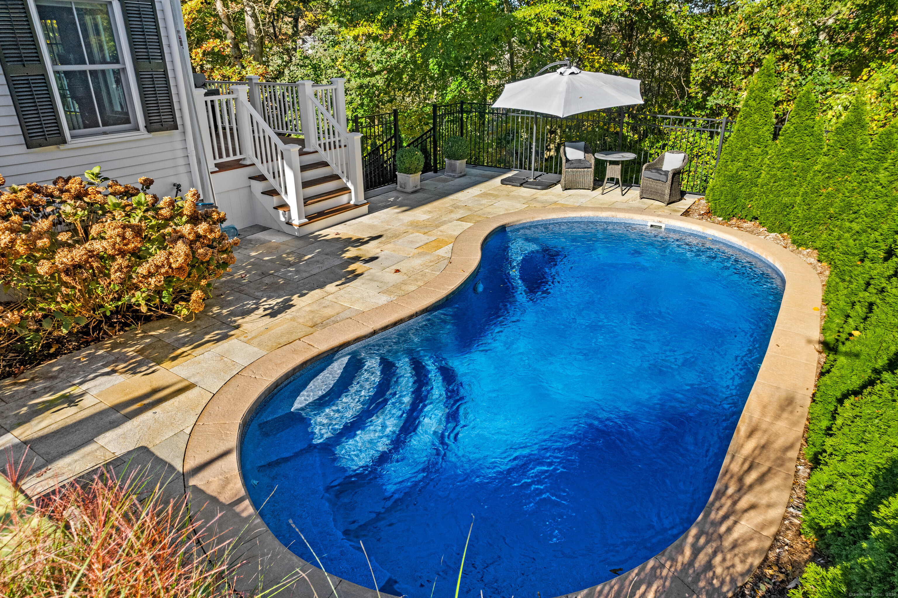 1 Hathaway Road East Lyme, CT 06333 - Photo 2 of 38 The saltwater heated pool is surrounded by a fence and privacy shrubs