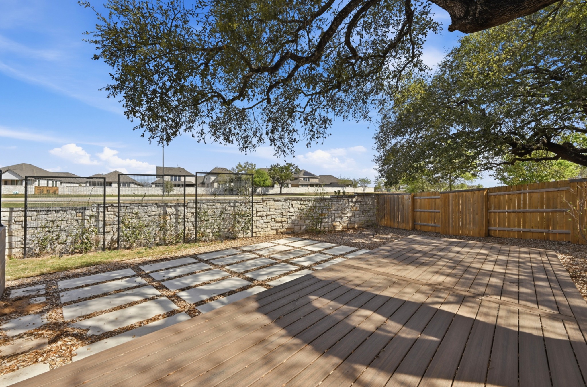 208 West Branch Road Kyle, TX 78640 - Photo 21 of 27 Between the layered hardscaping, mature tree canopy, and extra space, the setting feels private, calm, and thoughtfully designed.