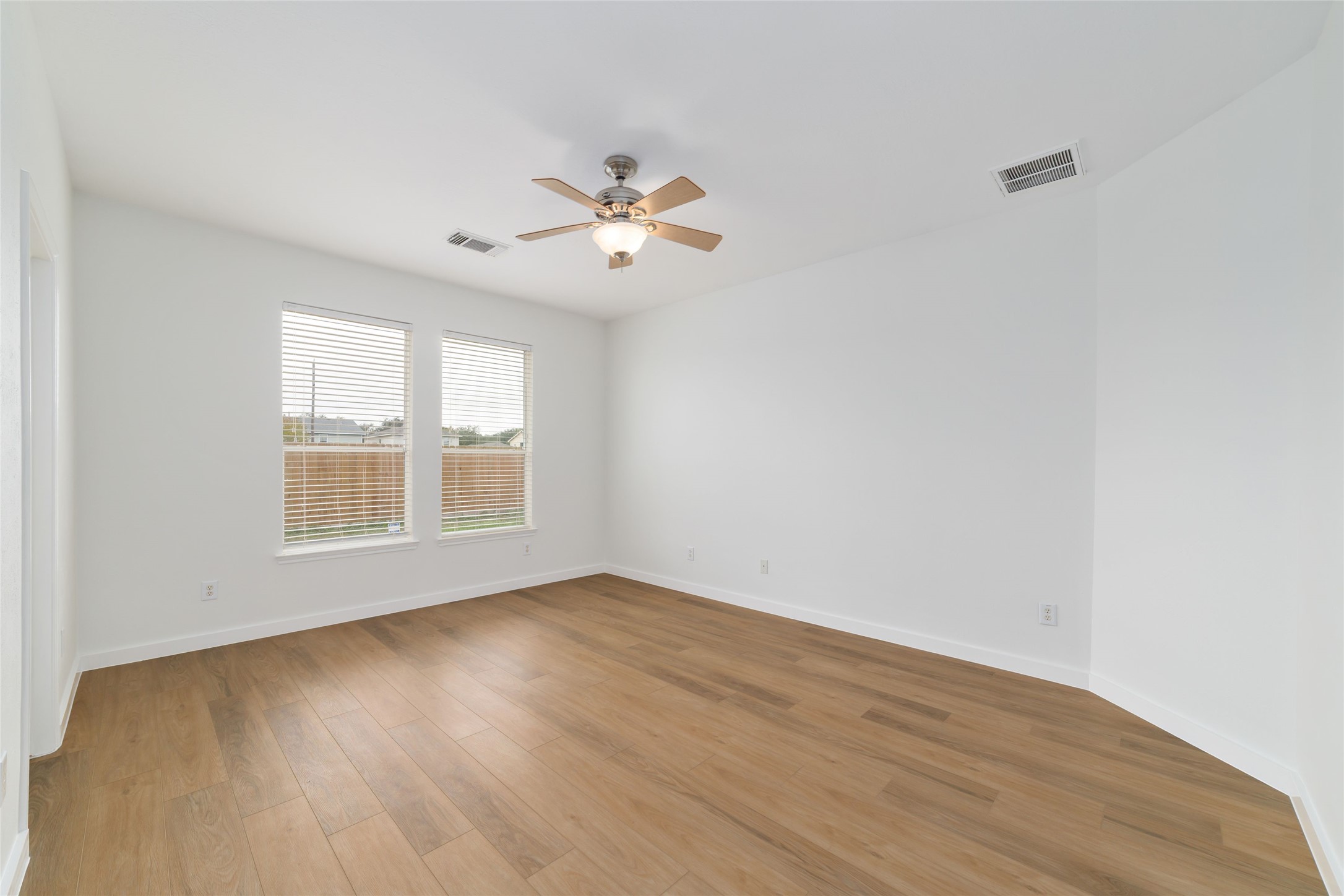 20215 Enchanted Rose Cypress, TX 77433 - Photo 17 of 23 a view of an empty room with a window and wooden floor