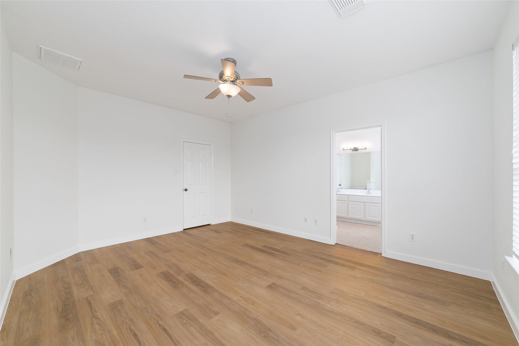 20215 Enchanted Rose Cypress, TX 77433 - Photo 18 of 23 a view of empty room with wooden floor and ceiling fan