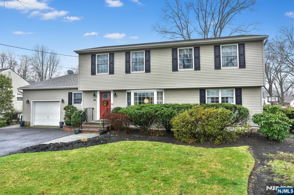 84 West Midland Avenue Paramus, NJ 07652 - Photo 1 of 37 a front view of a house with a yard