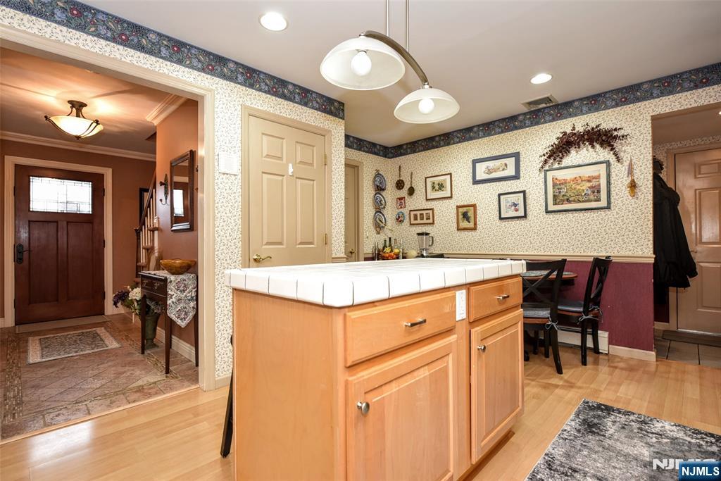 84 West Midland Avenue Paramus, NJ 07652 - Photo 13 of 37 a view of kitchen center island dining table and chairs