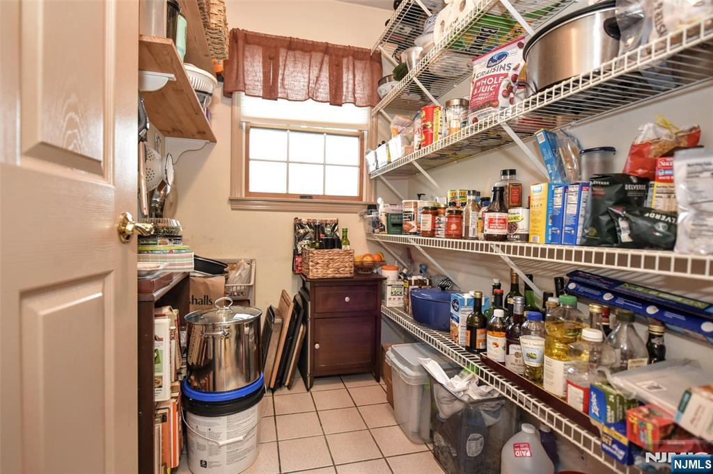 84 West Midland Avenue Paramus, NJ 07652 - Photo 15 of 37 a room filled with lots of wooden furniture and a chandelier