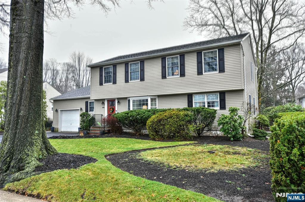 84 West Midland Avenue Paramus, NJ 07652 - Photo 2 of 37 a front view of a house with garden and porch