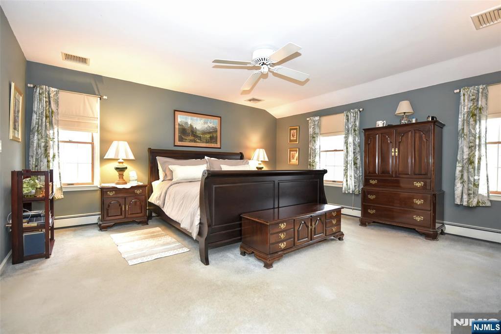 84 West Midland Avenue Paramus, NJ 07652 - Photo 23 of 37 a bedroom with a bed dresser and a window