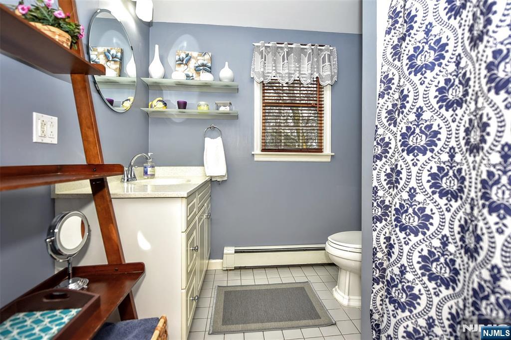 84 West Midland Avenue Paramus, NJ 07652 - Photo 27 of 37 a bathroom with a toilet a sink and a shower