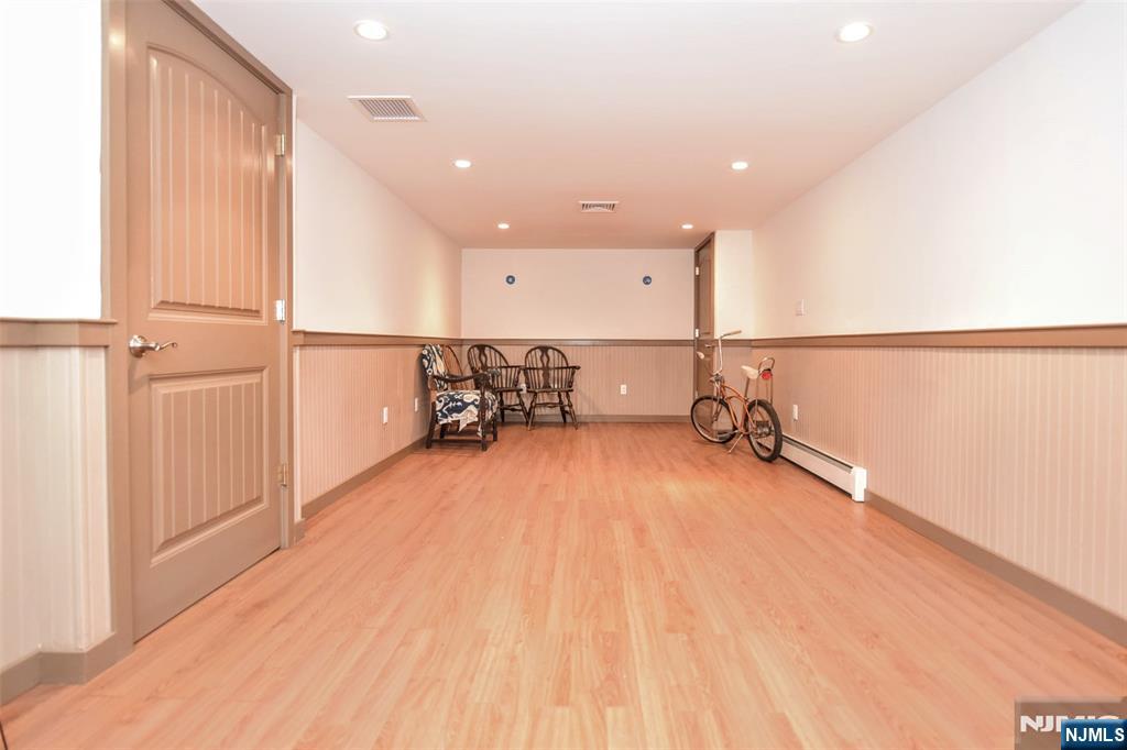 84 West Midland Avenue Paramus, NJ 07652 - Photo 28 of 37 a view of a room with gym equipment and wooden floor
