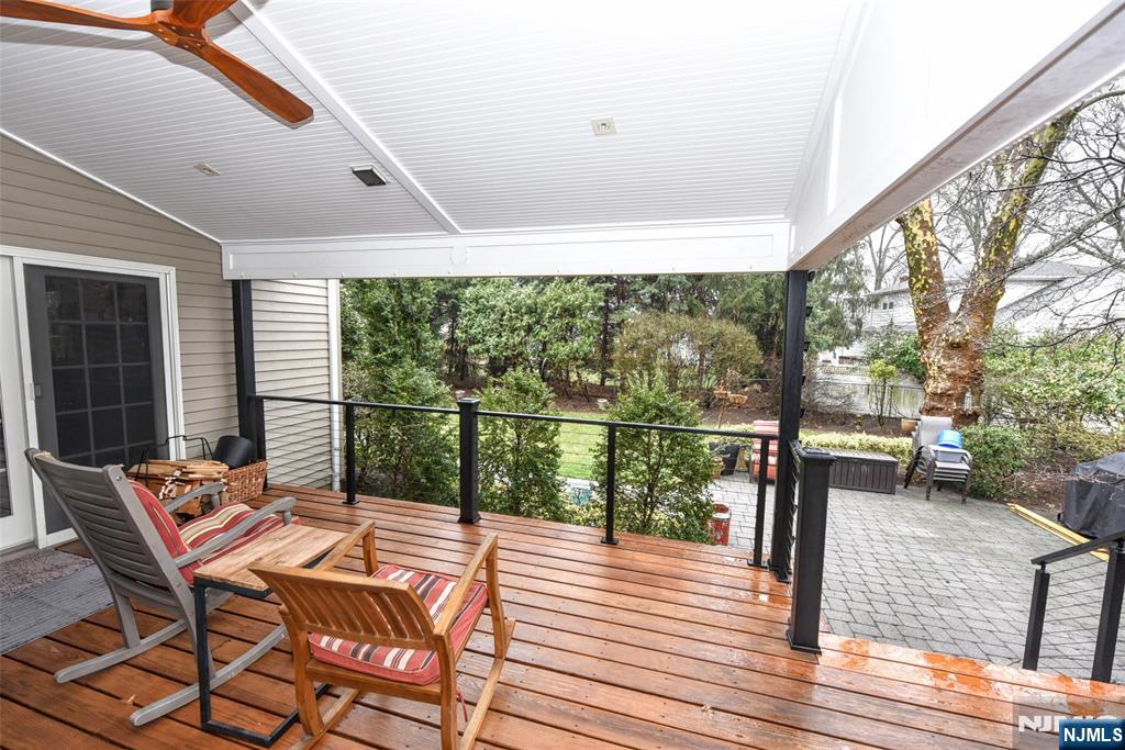 84 West Midland Avenue Paramus, NJ 07652 - Photo 29 of 37 a balcony with wooden floor table and chairs