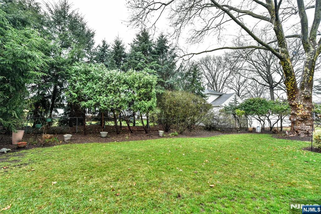84 West Midland Avenue Paramus, NJ 07652 - Photo 31 of 37 a backyard of a house with lots of green space