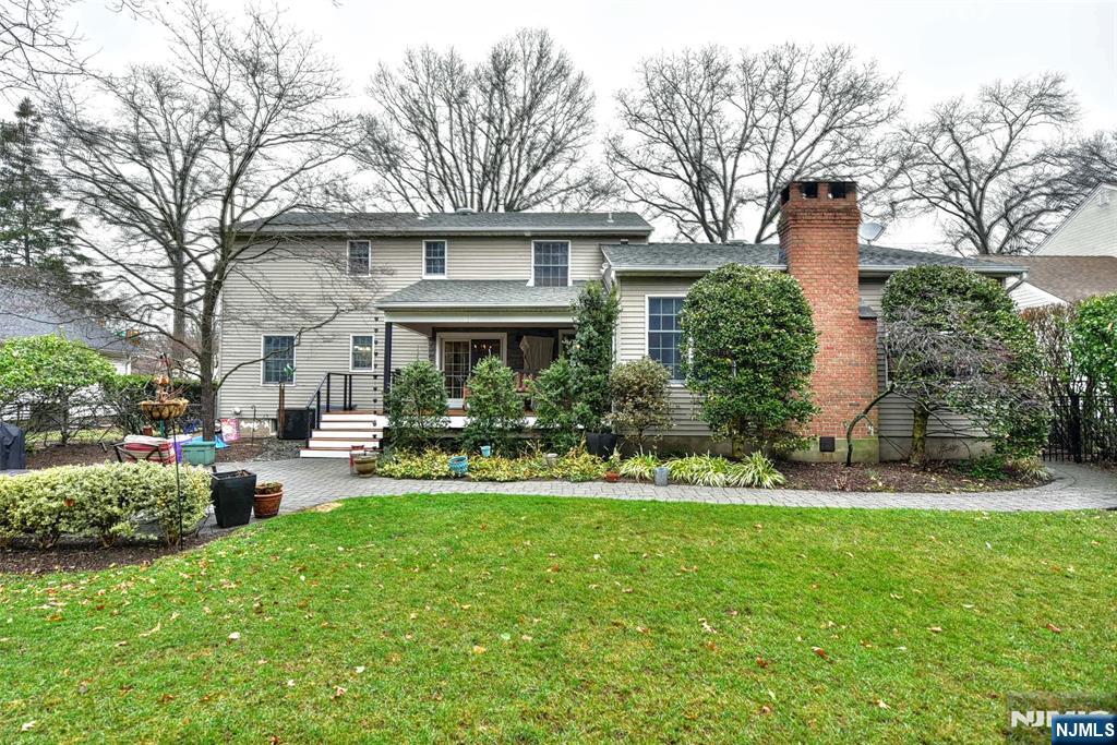 84 West Midland Avenue Paramus, NJ 07652 - Photo 32 of 37 a front view of a house with a yard and trees