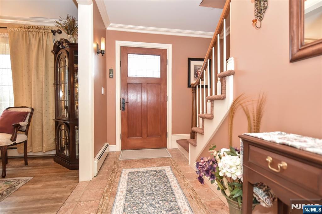 84 West Midland Avenue Paramus, NJ 07652 - Photo 4 of 37 a view of an entryway with wooden floor and staircase