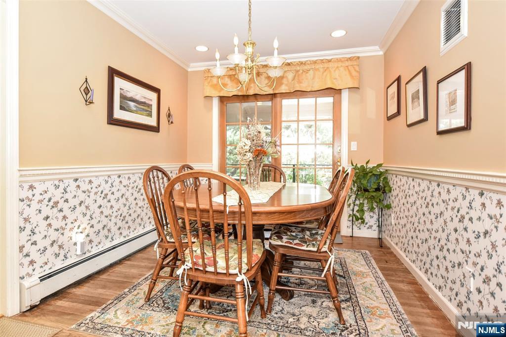 84 West Midland Avenue Paramus, NJ 07652 - Photo 8 of 37 a view of a dining room with furniture wooden floor and chandelier