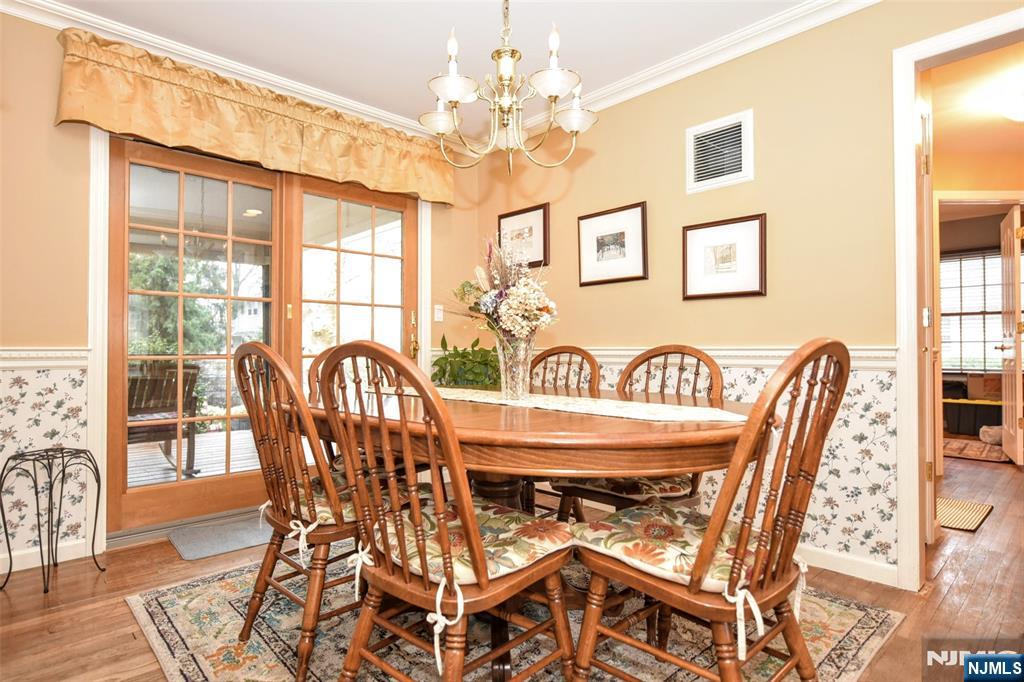 84 West Midland Avenue Paramus, NJ 07652 - Photo 9 of 37 a view of a dining room with furniture wooden floor and chandelier