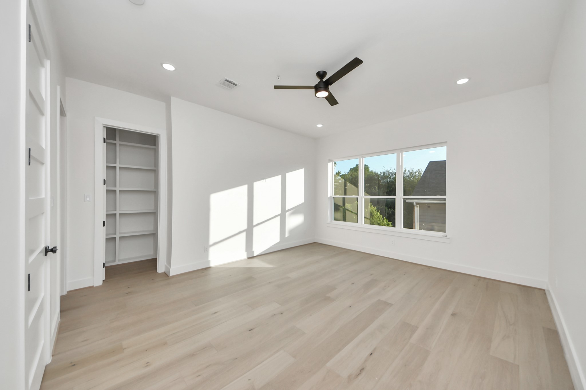 4819 Austin Street, Unit B Houston, TX 77004 - Photo 23 of 49 a view of an empty room with a window and wooden floor