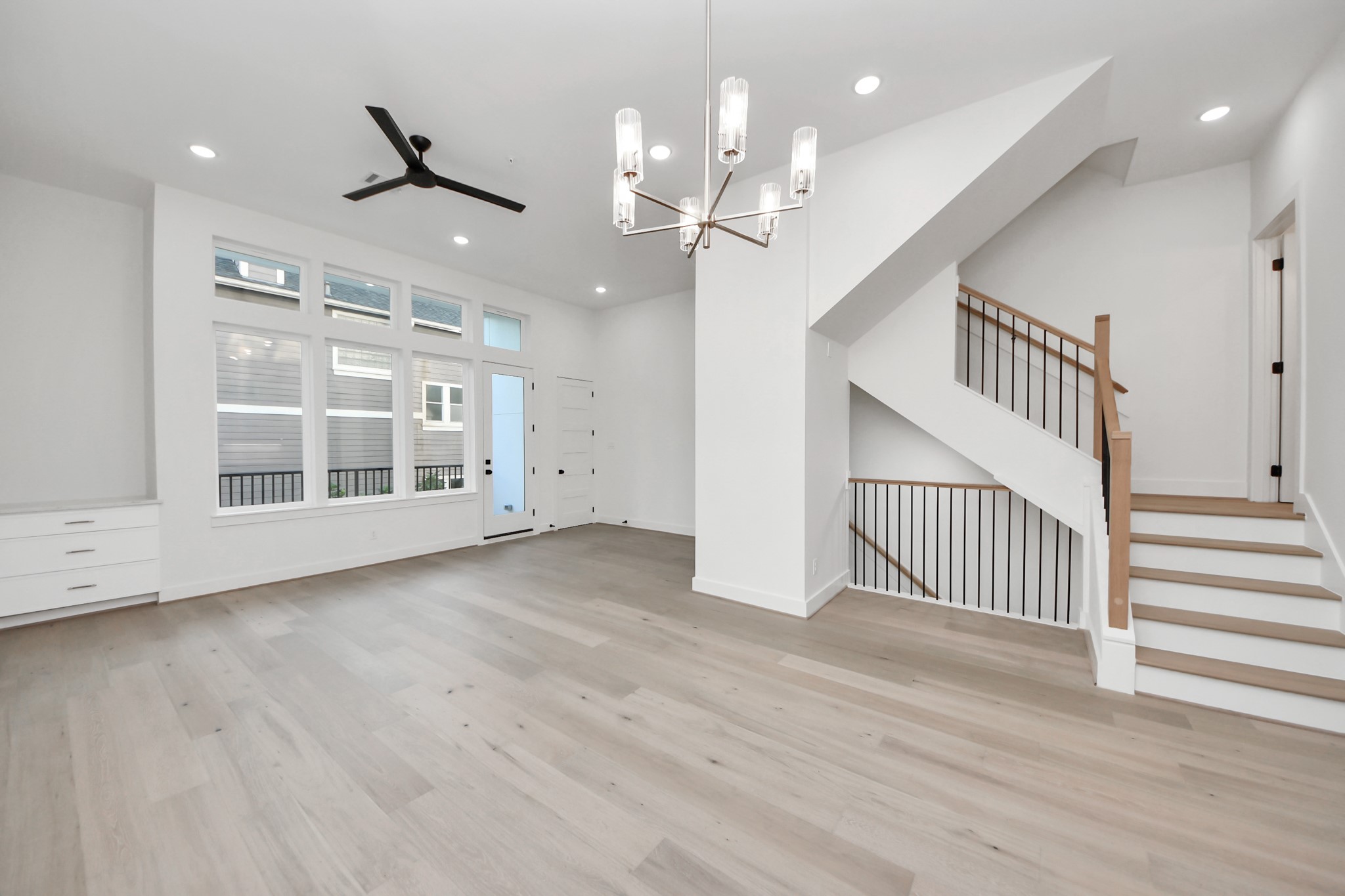 4819 Austin Street, Unit B Houston, TX 77004 - Photo 10 of 49 an empty room with wooden floor chandelier and windows