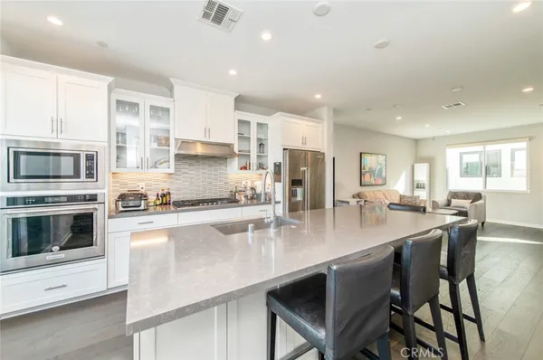 a large kitchen with granite countertop lots of counter space a sink and appliances