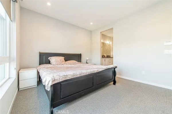 a spacious bedroom with a bed and a window