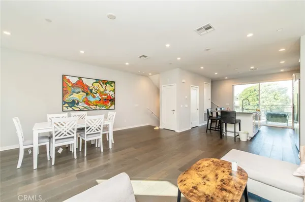 a living room with furniture a coffee table and a floor to ceiling window
