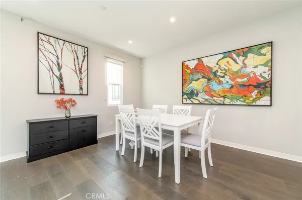 a view of a dining room with furniture wooden floor and window