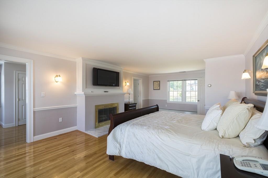 481 Jerusalem Road Cohasset, MA 02025 - Photo 13 of 30 a bedroom with a bed and a flat screen tv