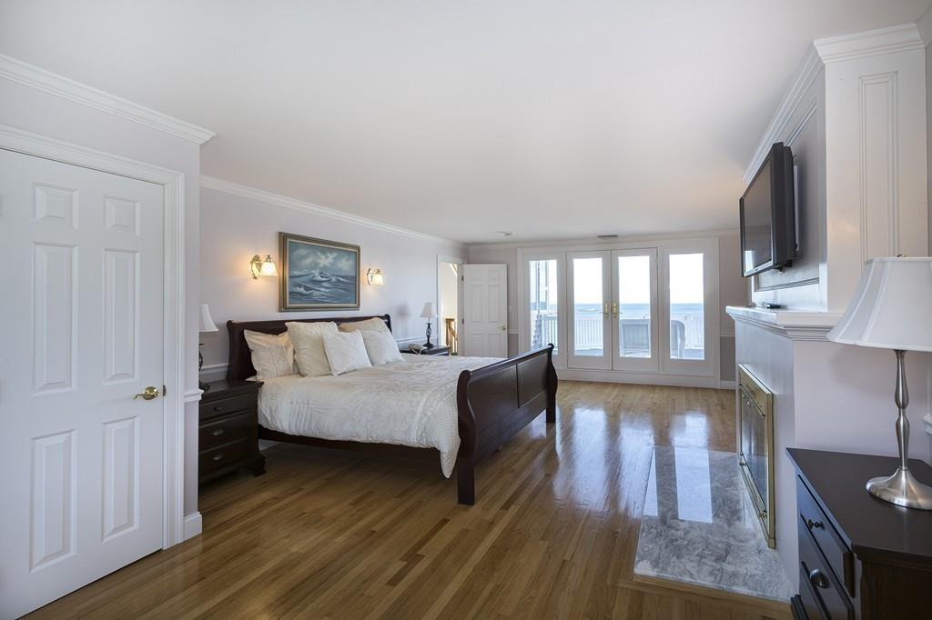 481 Jerusalem Road Cohasset, MA 02025 - Photo 14 of 30 a spacious bedroom with a bed windows and wooden floor