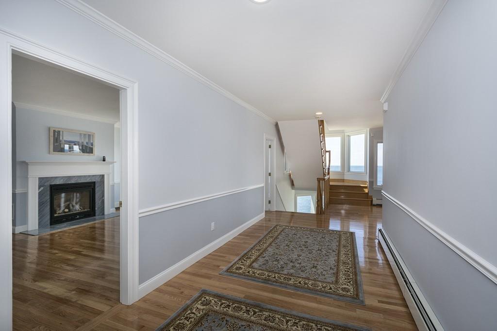 481 Jerusalem Road Cohasset, MA 02025 - Photo 8 of 30 a view of a hallway view with wooden floor and a fireplace
