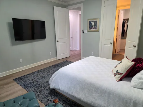a bedroom with a bed and a flat screen tv