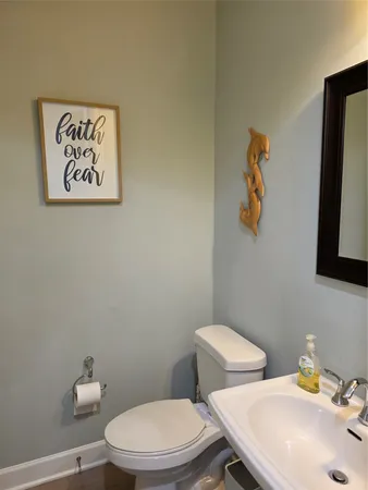 a white toilet sitting next to a bathroom sink