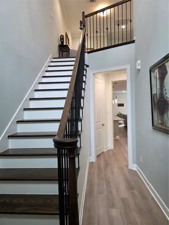 a view of entryway and hall with wooden floor