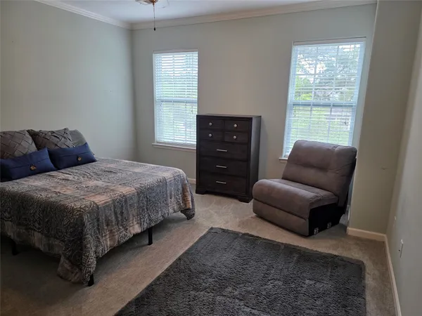 a spacious bedroom with a bed and furniture