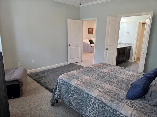 a bedroom with a bed and a couch