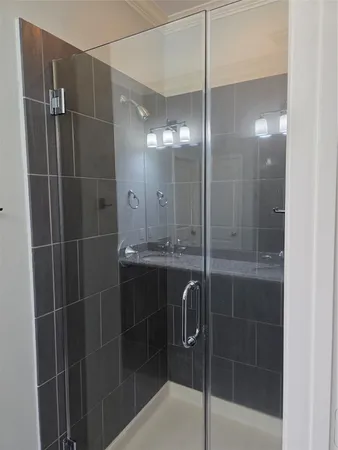 a bathroom with a shower and a sink