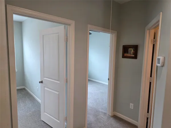 a view of a hallway with closet and front door