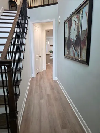 a view of a hallway view with wooden floor and staircase