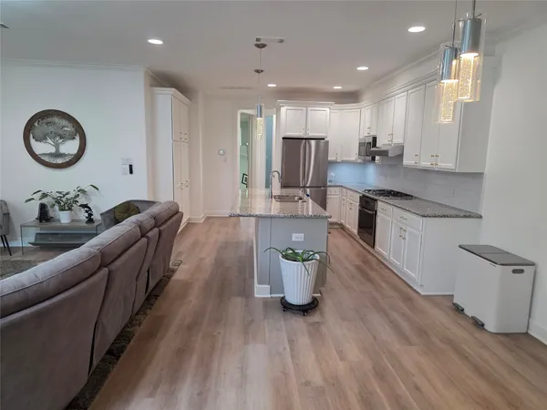 a large room with kitchen island a lot of counter space