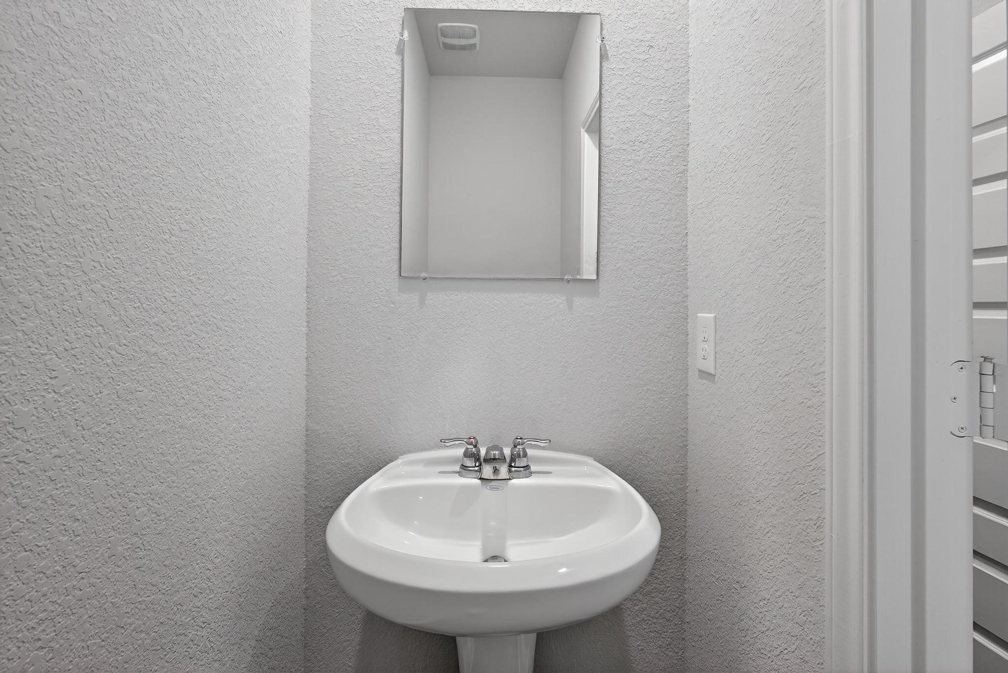 1409 Mount Bassie Trail Conroe, TX 77301 - Photo 20 of 26 a bathroom with a sink and a mirror