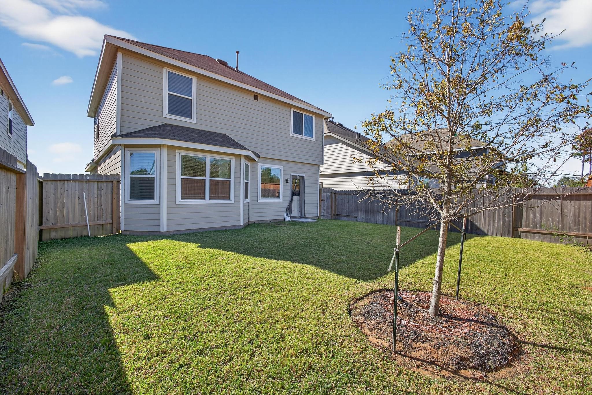 1409 Mount Bassie Trail Conroe, TX 77301 - Photo 22 of 26 a view of a house with a yard