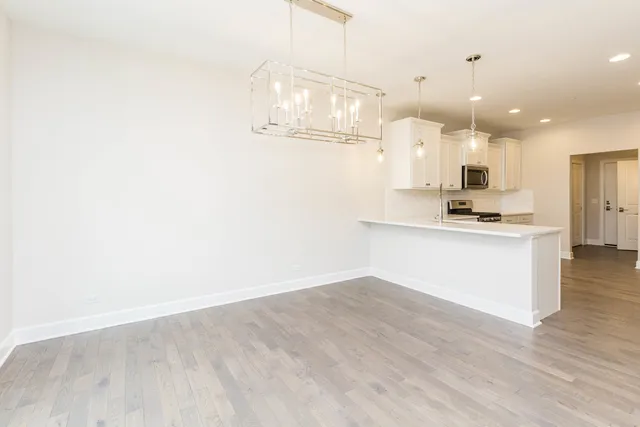 a view of kitchen with granite countertop cabinets and refrigerator