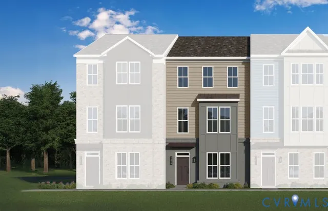 a view of a large white building next to a yard