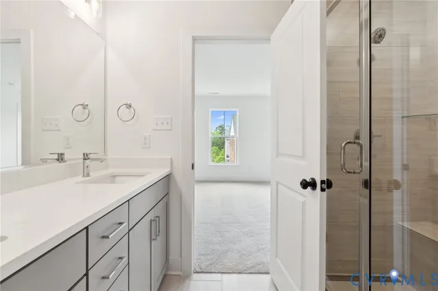 a bathroom with a granite countertop sink a shower and a mirror