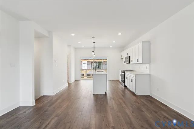 a view of a kitchen with wooden floor and a window