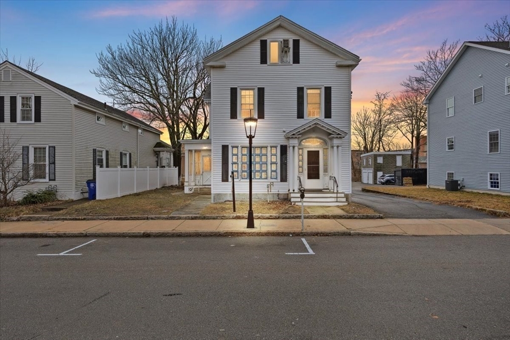 a front view of a house with a street