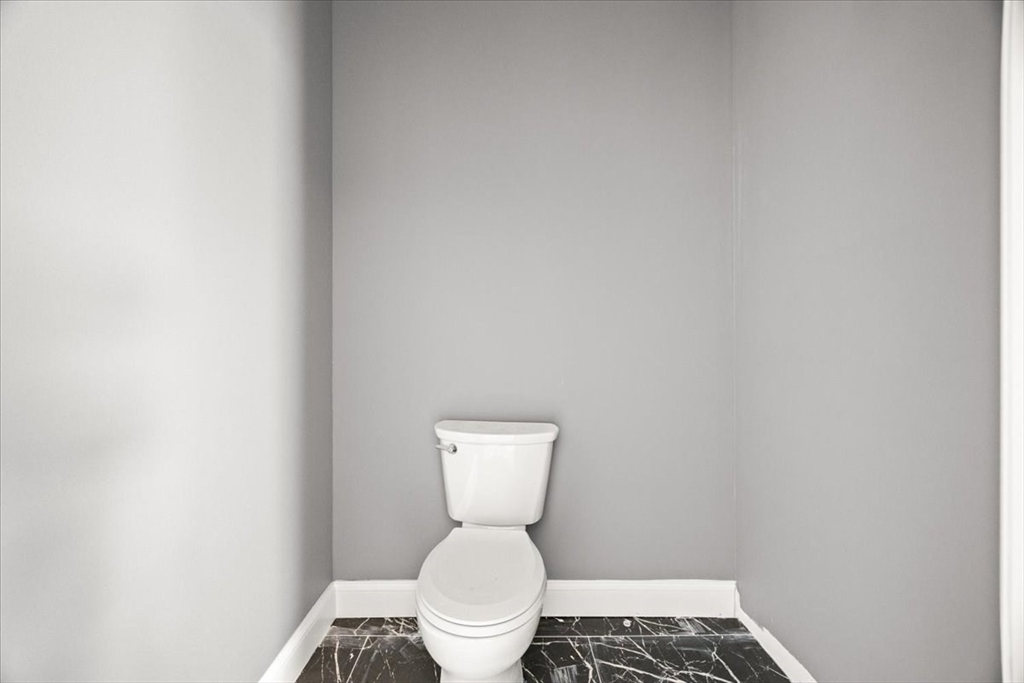 150 Purchase Street Fall River, MA 02720 - Photo 16 of 42 a white toilet sitting next to a white wall