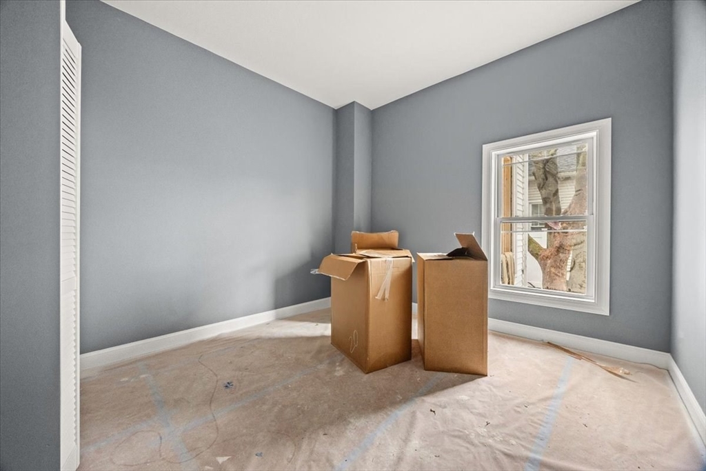 150 Purchase Street Fall River, MA 02720 - Photo 18 of 42 a bed room with a window and a lamp