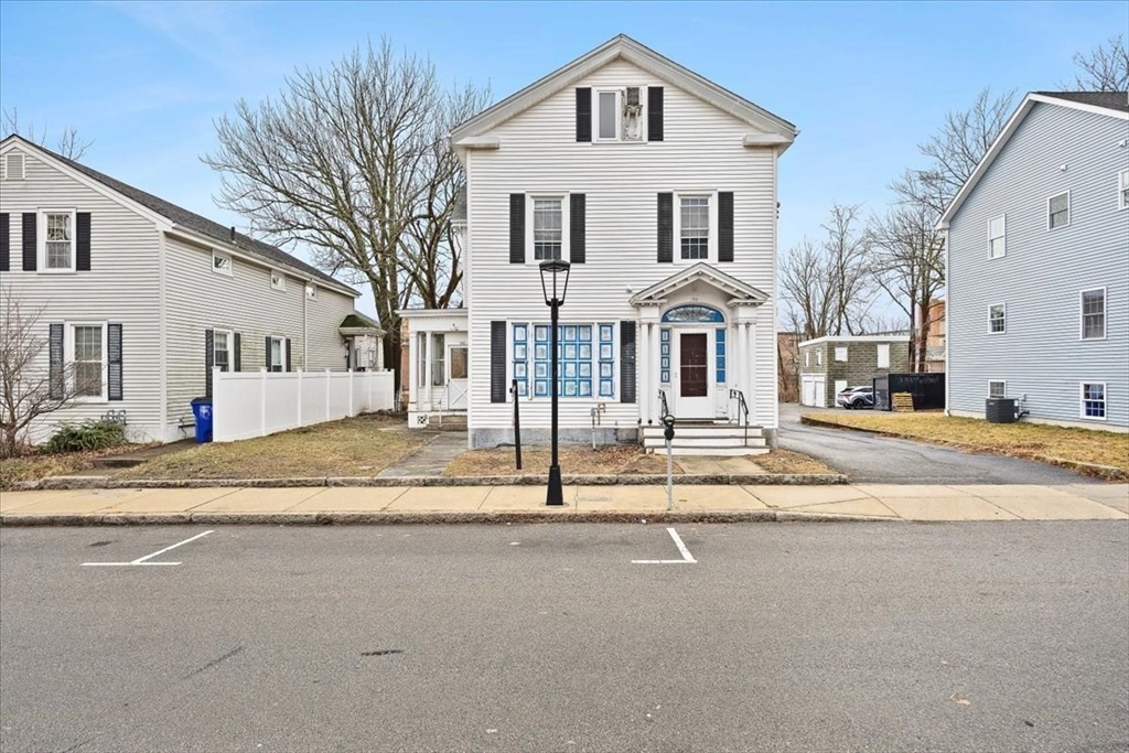 150 Purchase Street Fall River, MA 02720 - Photo 2 of 42 a front view of a house with a yard