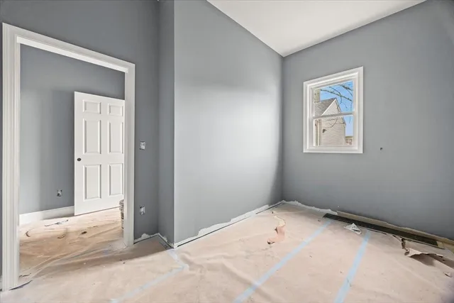 a view of a room with a large window and chair