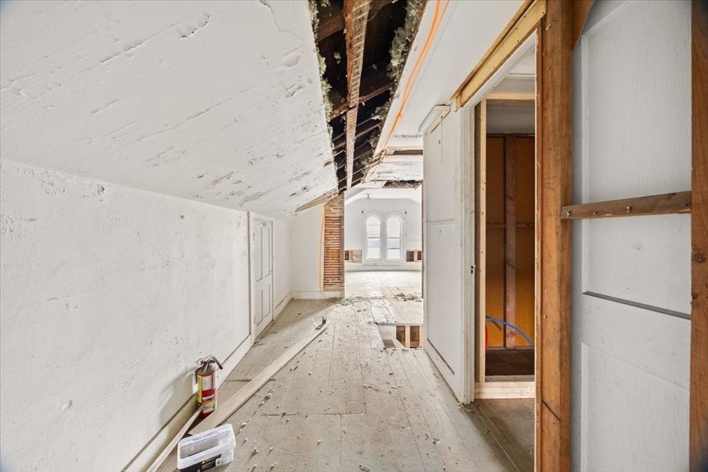 150 Purchase Street Fall River, MA 02720 - Photo 33 of 42 a view of a hallway with a white walls and stairs