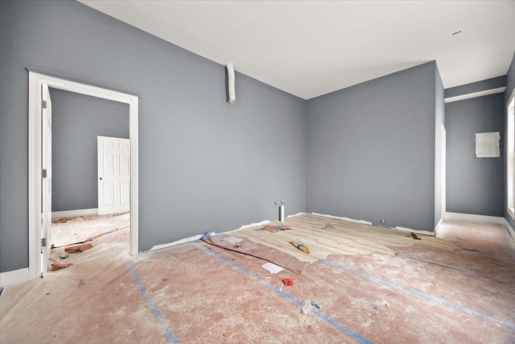 150 Purchase Street Fall River, MA 02720 - Photo 7 of 42 a bedroom with a bed and mirror